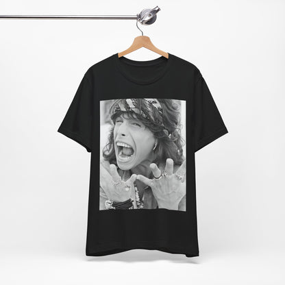 A black graphic t-shirt featuring a candid, dynamic photo of Aerosmith band members on tour in the 1970s, possibly showing action or interaction on stage or backstage.