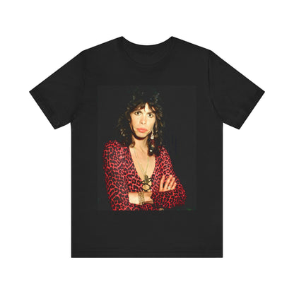 A black graphic t-shirt featuring a vintage 70s-inspired design with Aerosmith branding, incorporating a prominent leopard print pattern.