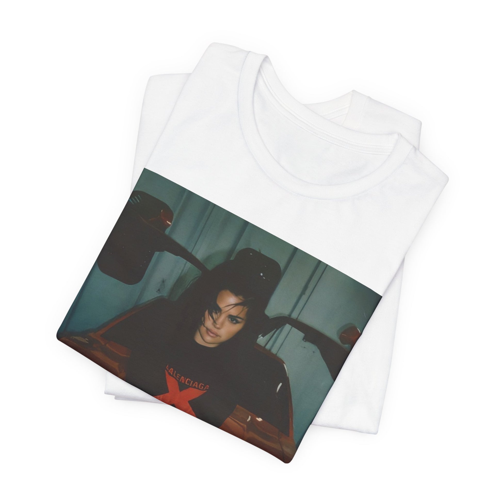 A black graphic t-shirt featuring a photo or graphic of Selena Gomez with a car, designed with an 'X Rated' or edgy aesthetic.