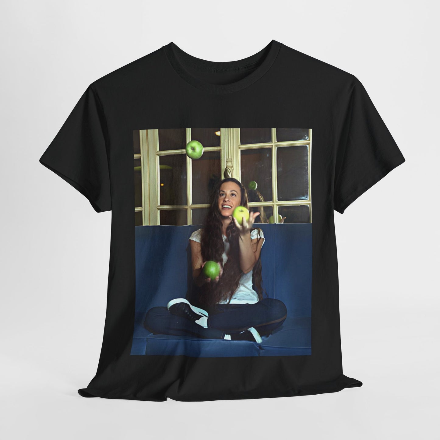 A black graphic t-shirt featuring a candid photo of Alanis Morissette sitting on a couch, looking relaxed or thoughtful.