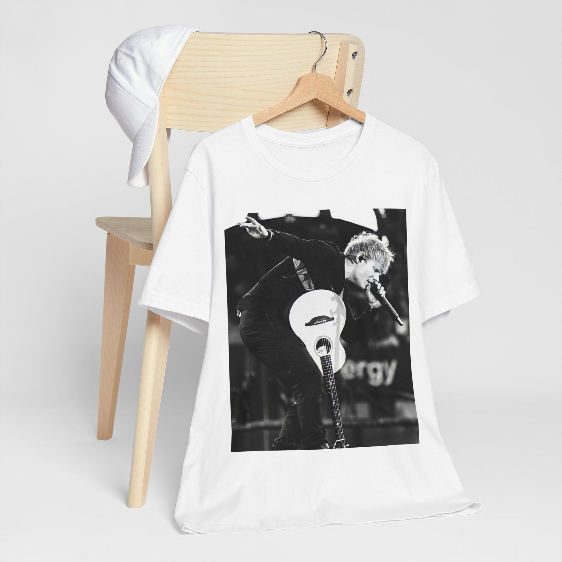 A black graphic t-shirt featuring a vintage graphic of Ed Sheeran performing live.