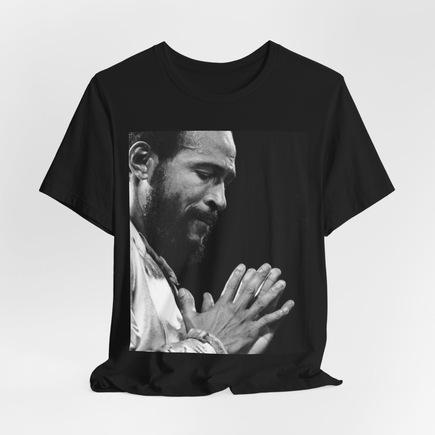 A black graphic t-shirt featuring a 70s graphic of Marvin Gaye emphasizing his soulful voice.