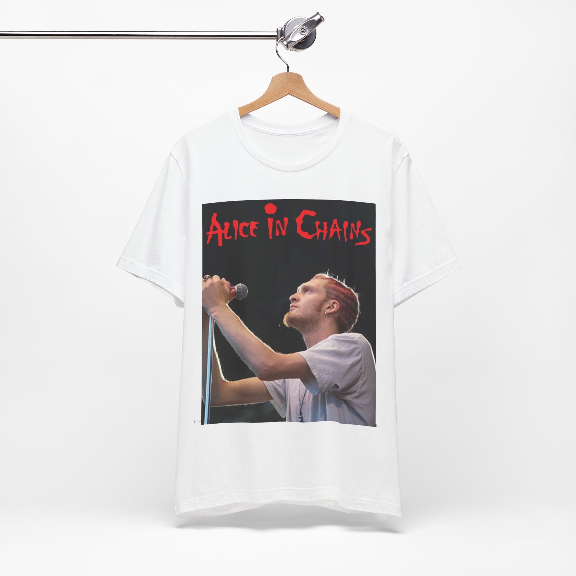 A black graphic t-shirt featuring the Alice In Chains logo in red, in a 90s grunge style.