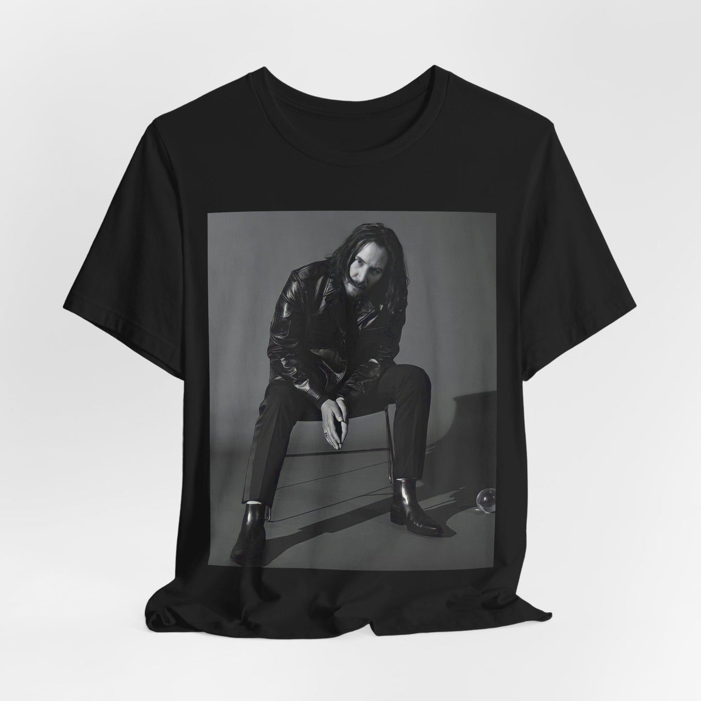 A black graphic t-shirt featuring a graphic of Keanu Reeves as John Wick.