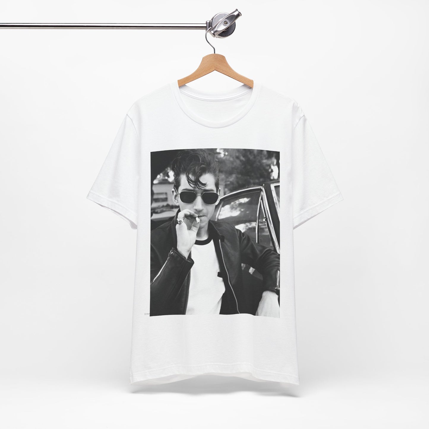 A black graphic t-shirt featuring a classic rock-style graphic of the Arctic Monkeys, possibly with band members in a stylized design.