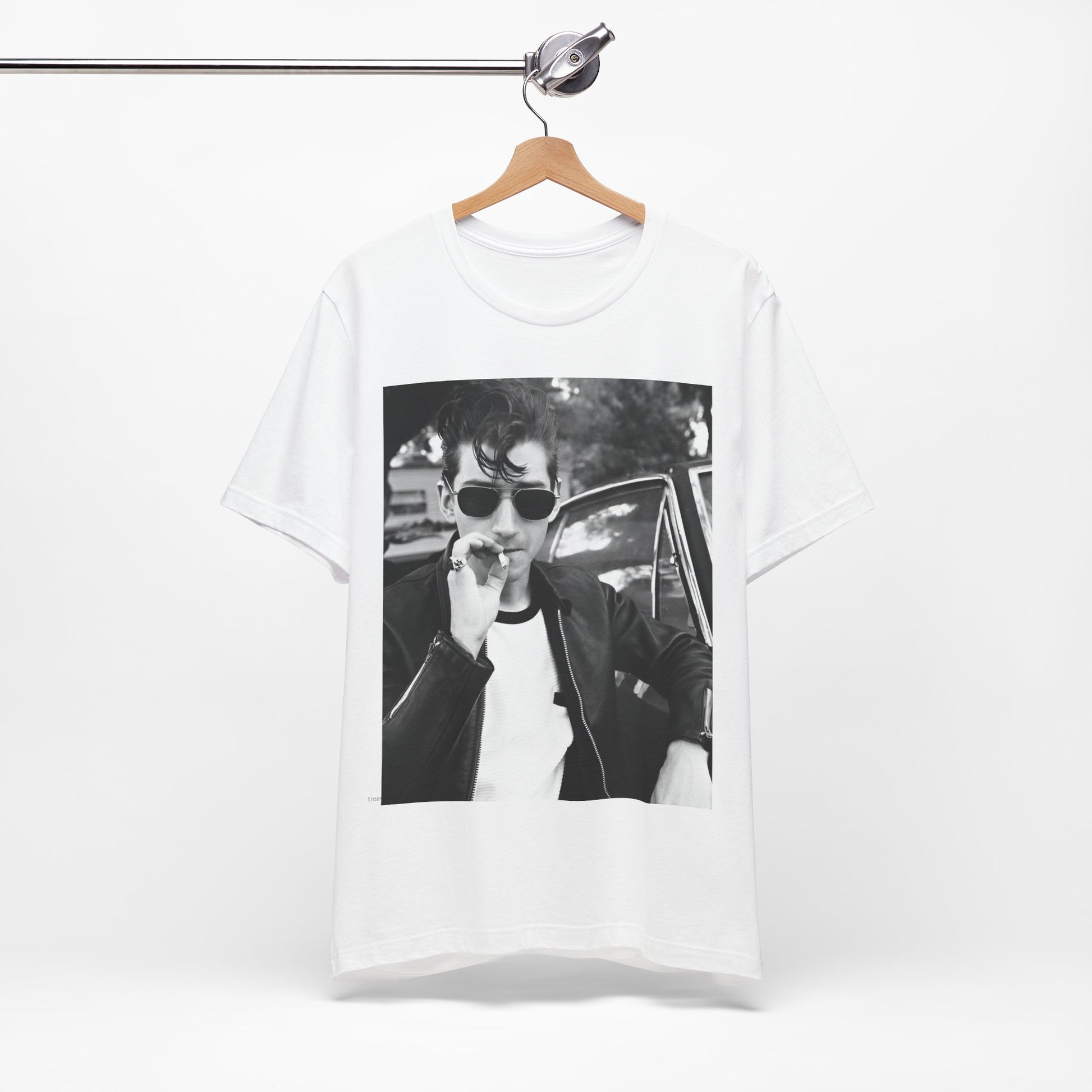 A black graphic t-shirt featuring a classic rock-style graphic of the Arctic Monkeys, possibly with band members in a stylized design.
