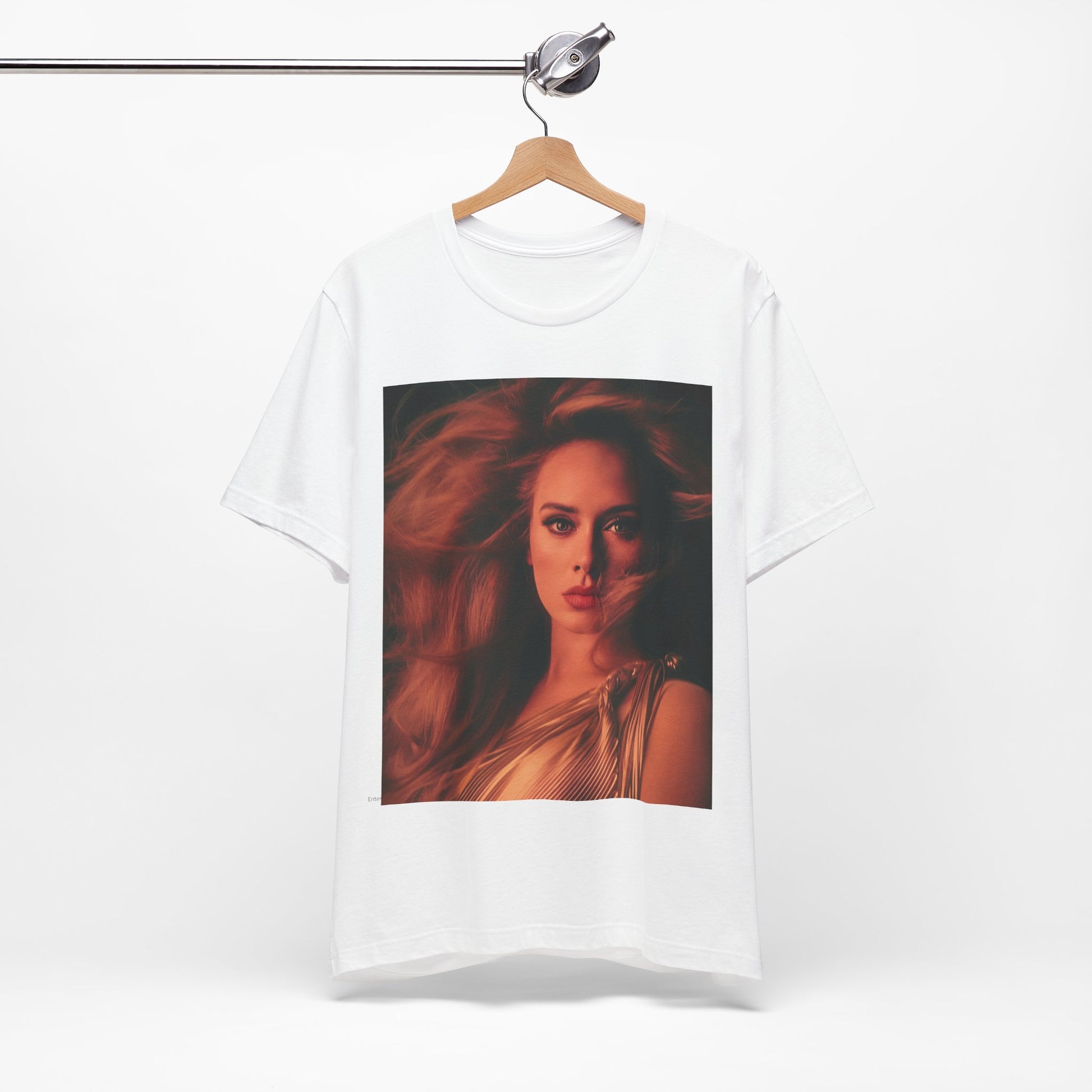 A black graphic t-shirt featuring a glamorous portrait of Adele wearing a golden gown, with voluminous hair, bathed in warm lighting, giving an editorial look.