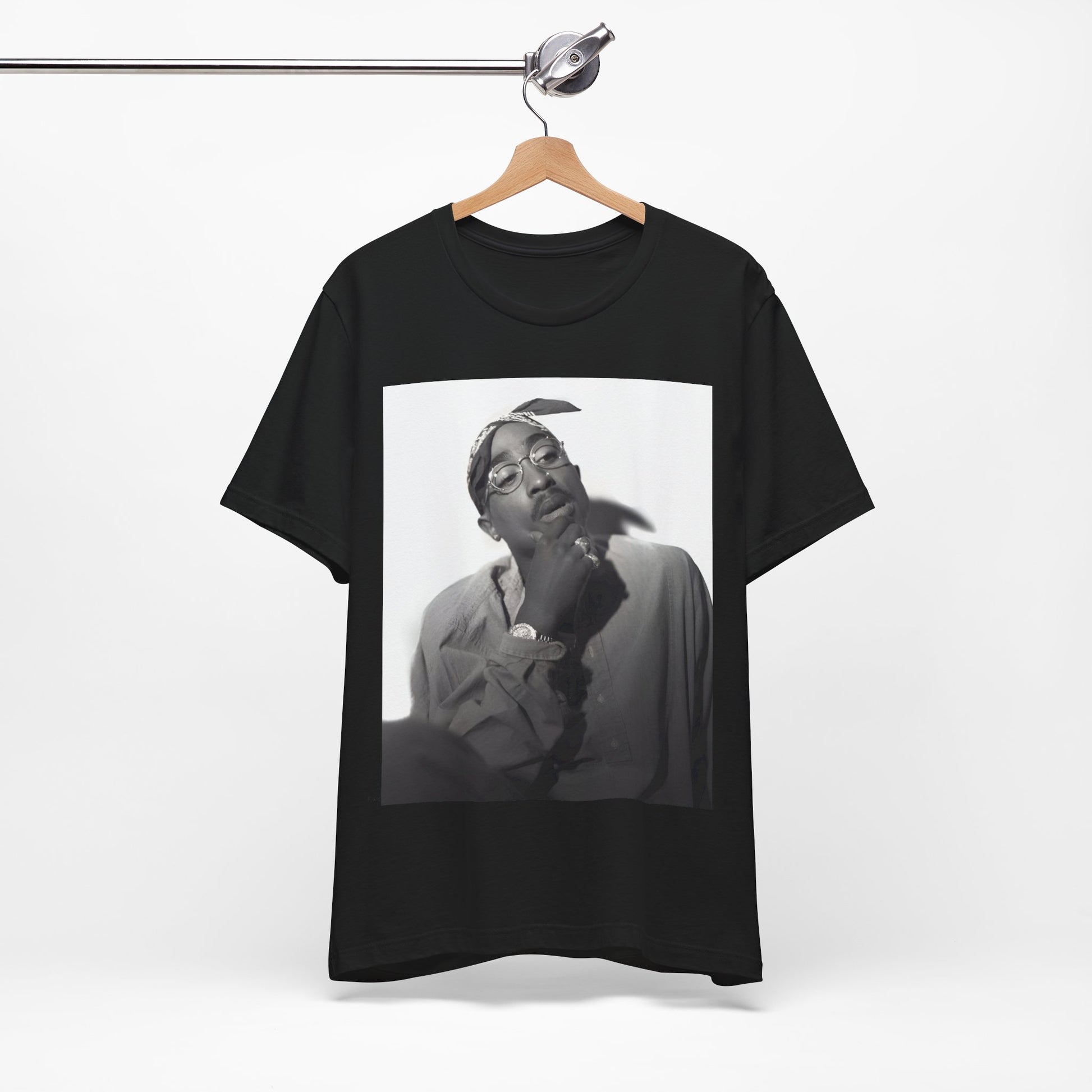 A black graphic t-shirt featuring a classic 90s West Coast rap graphic of Tupac.