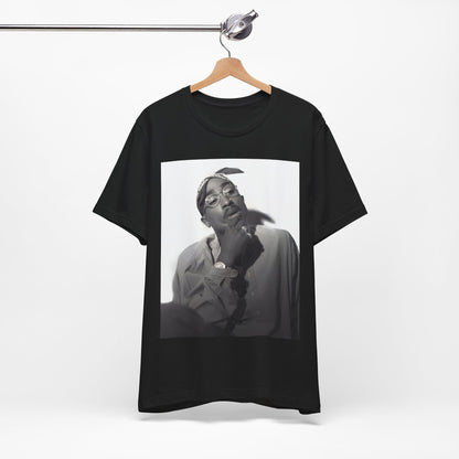 A black graphic t-shirt featuring a classic 90s West Coast rap graphic of Tupac.