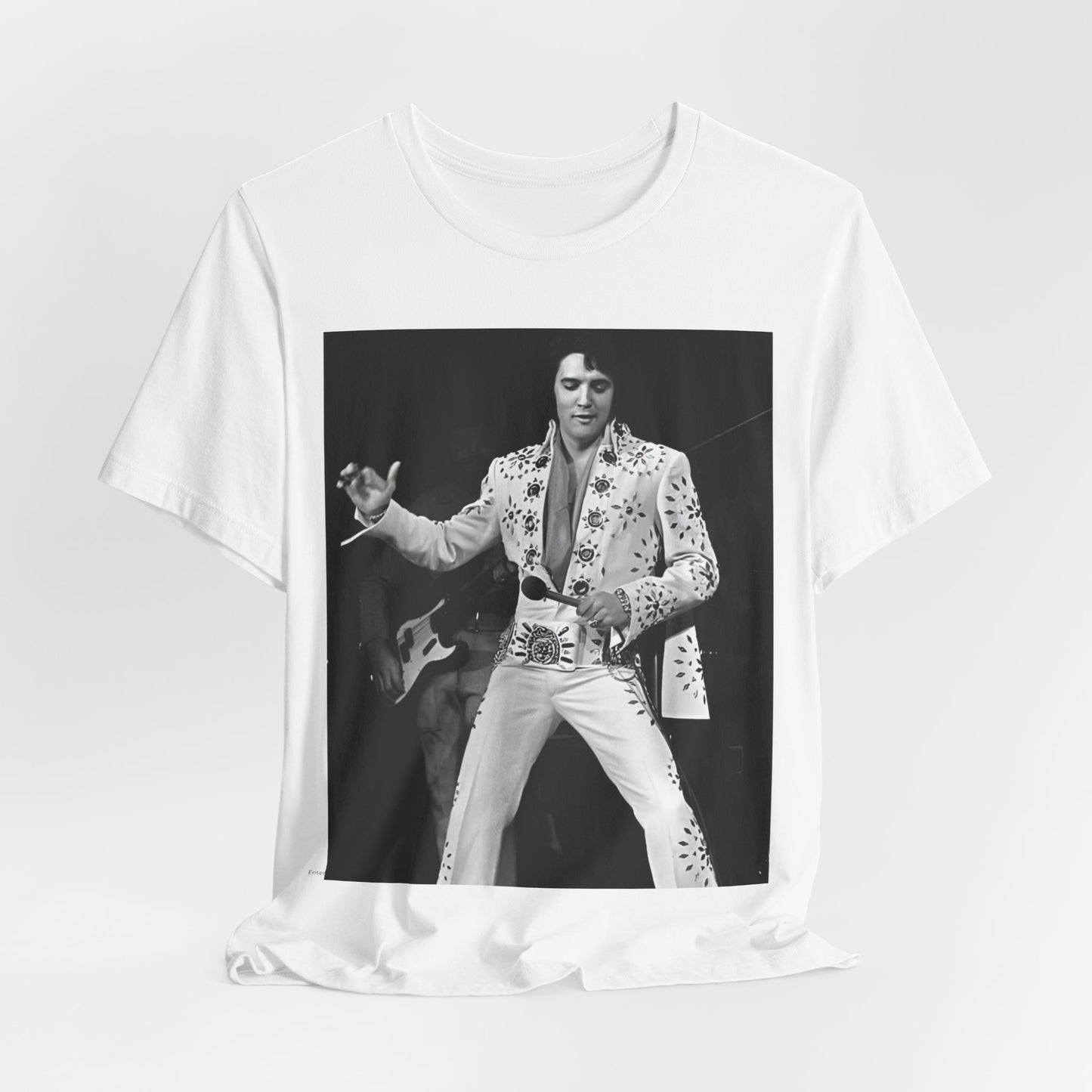 A black graphic t-shirt featuring a stylized graphic of Elvis Presley as The King of Rock 'n' Roll.