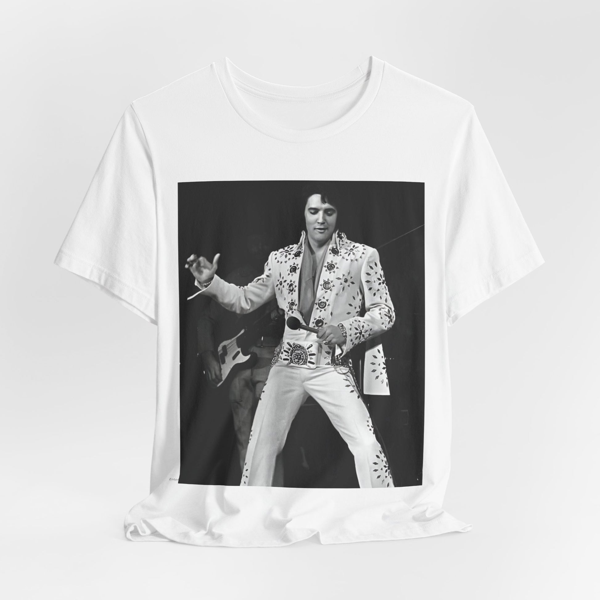 A black graphic t-shirt featuring a stylized graphic of Elvis Presley as The King of Rock 'n' Roll.