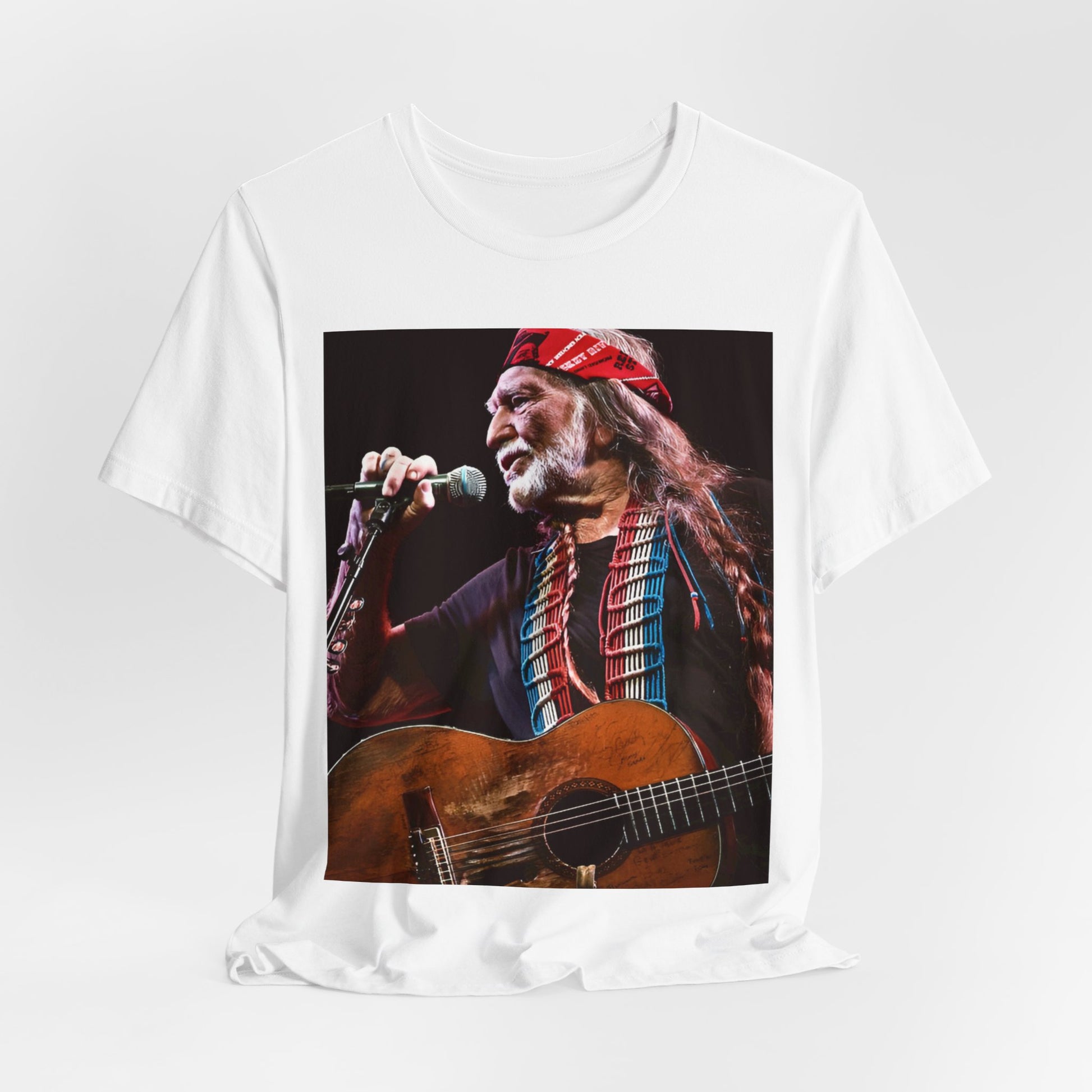 A black graphic t-shirt featuring a graphic of Willie Nelson with his iconic long hair and bandana.