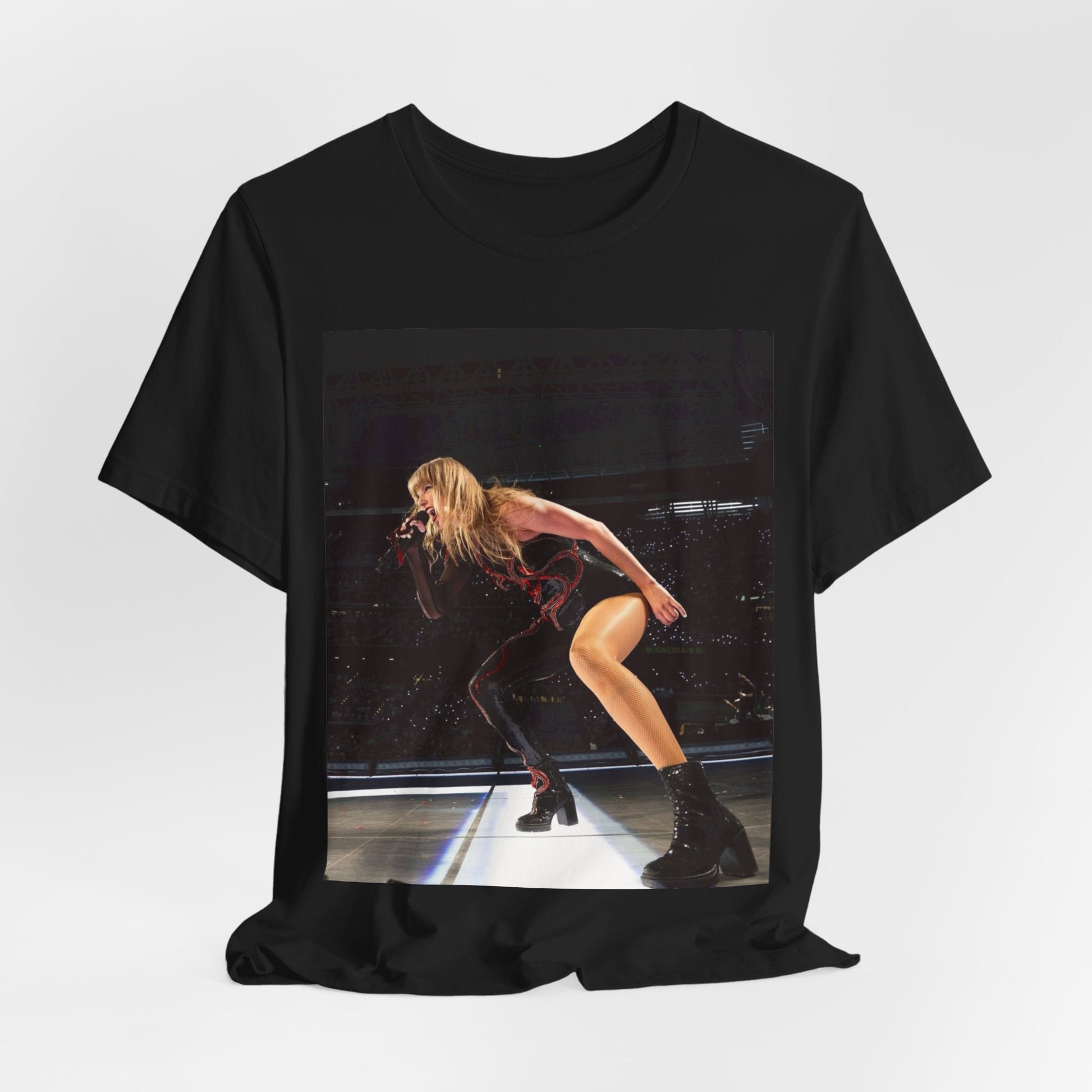 A black graphic t-shirt featuring a fierce graphic of Taylor Swift on stage.