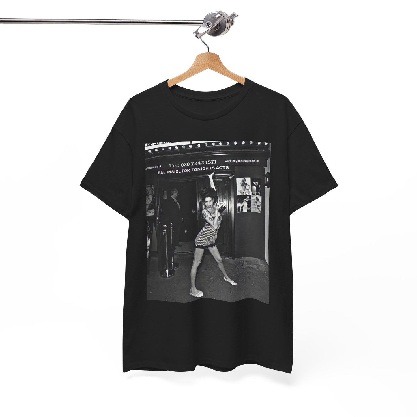 A black graphic t-shirt featuring a black and white graphic of Amy Winehouse in a burlesque club setting, stylized to evoke that ambiance.