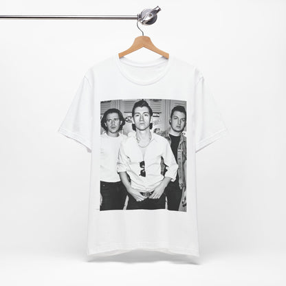 A black graphic t-shirt featuring a vintage-style design related to Arctic Monkeys' 'AM' album era, possibly with the album art or band imagery.