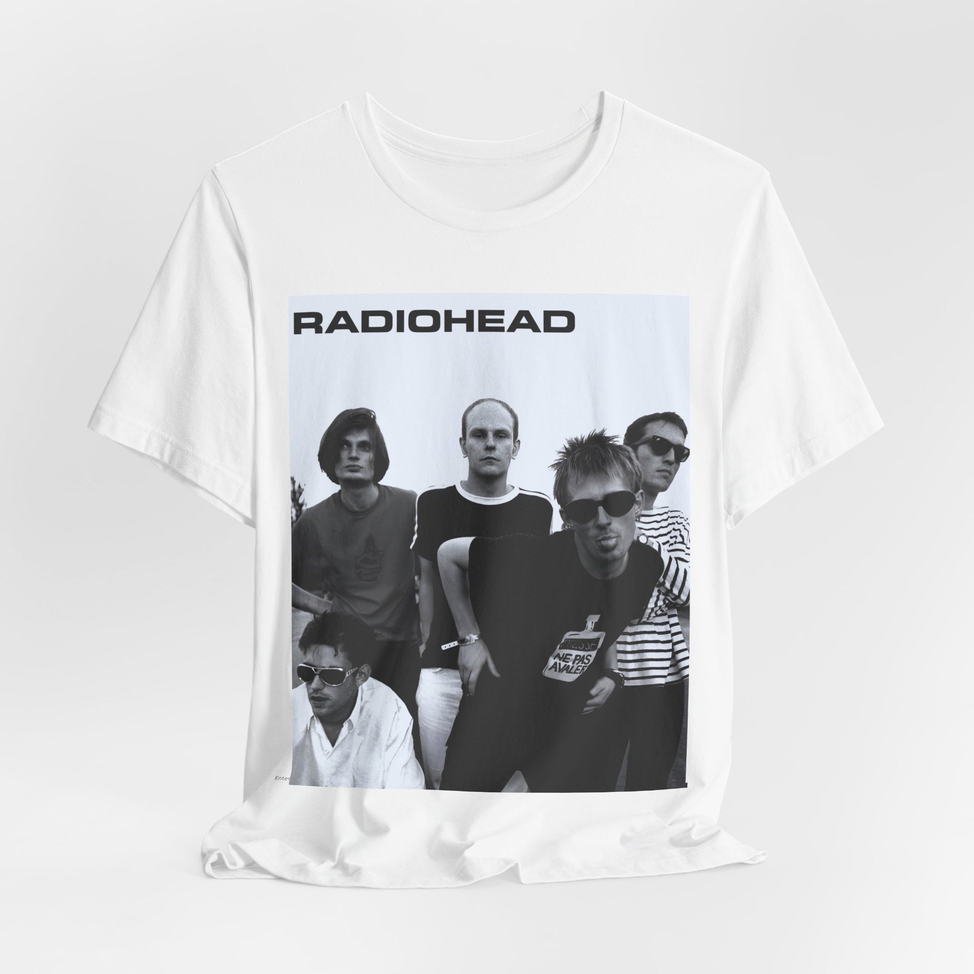A black graphic t-shirt featuring a vintage 90s graphic related to Radiohead's 'Creep' song or era.