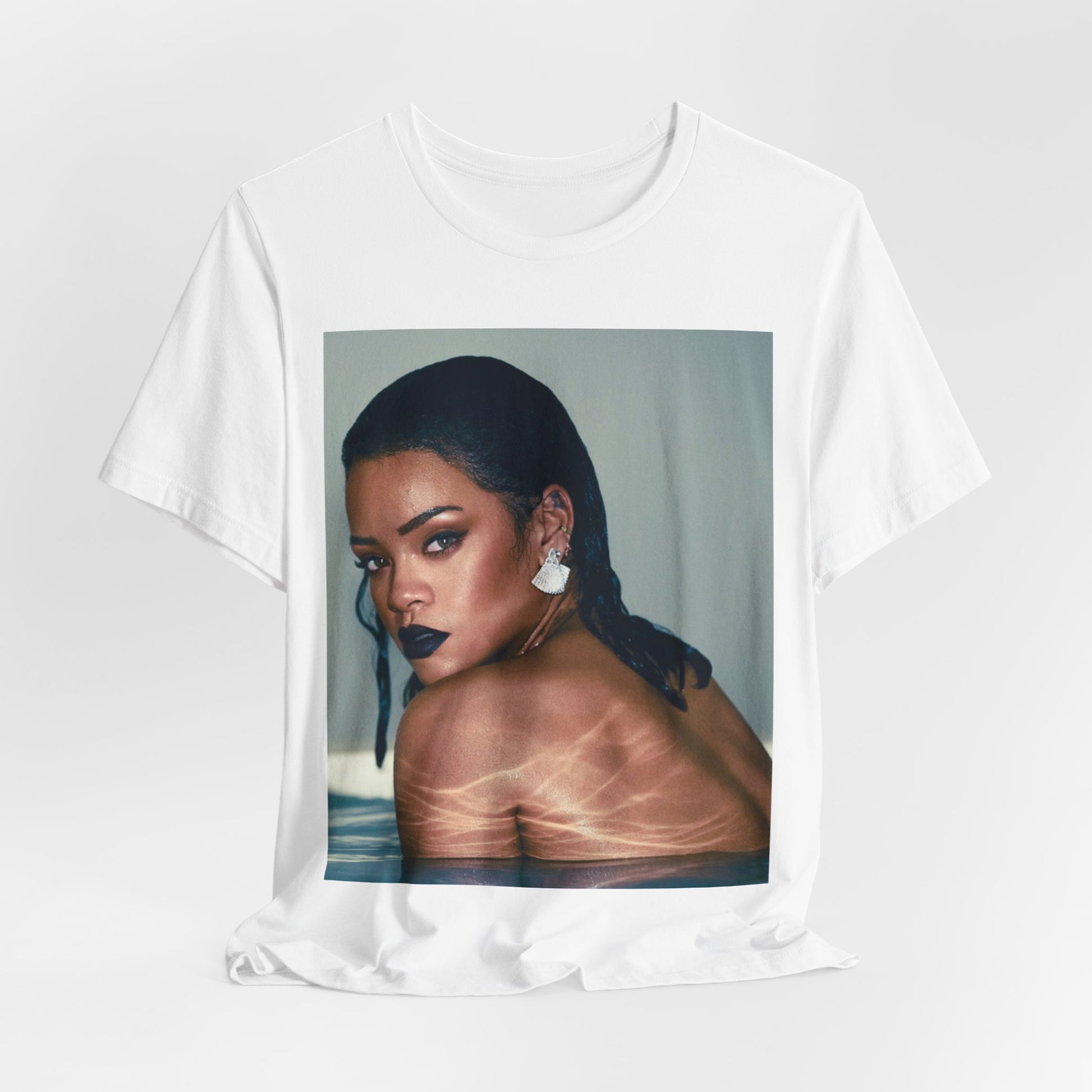 A black graphic t-shirt featuring a vintage pop icon graphic of Rihanna.