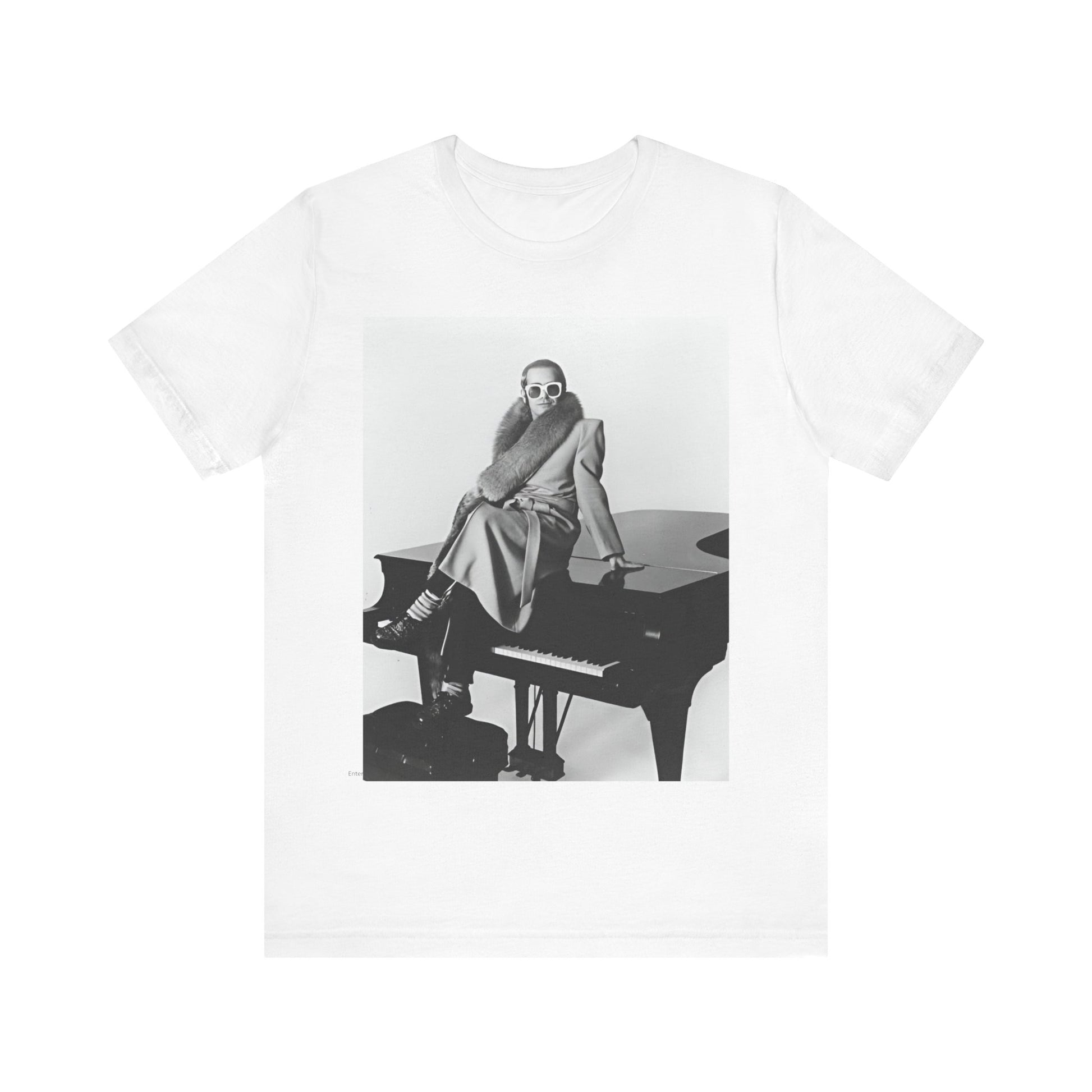 A black graphic t-shirt featuring a black and white photo of Elton John playing the piano.