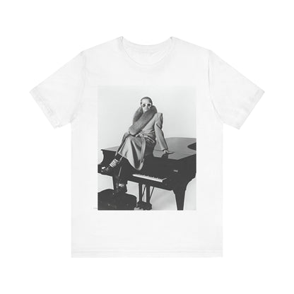 A black graphic t-shirt featuring a black and white photo of Elton John playing the piano.