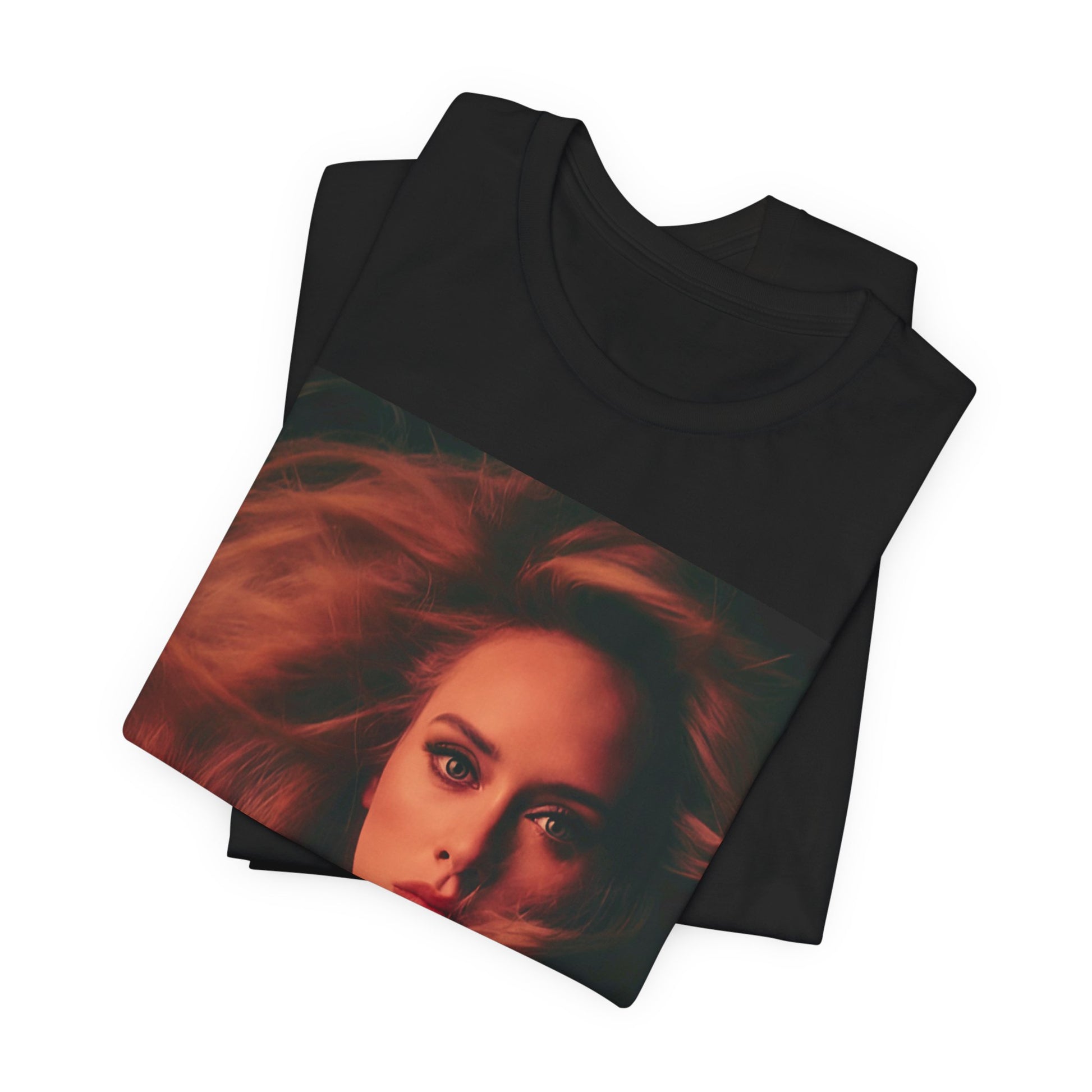 A black graphic t-shirt featuring a glamorous portrait of Adele wearing a golden gown, with voluminous hair, bathed in warm lighting, giving an editorial look.
