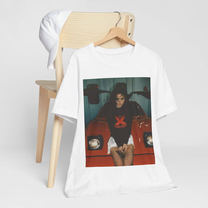 A black graphic t-shirt featuring a photo or graphic of Selena Gomez with a car, designed with an 'X Rated' or edgy aesthetic.