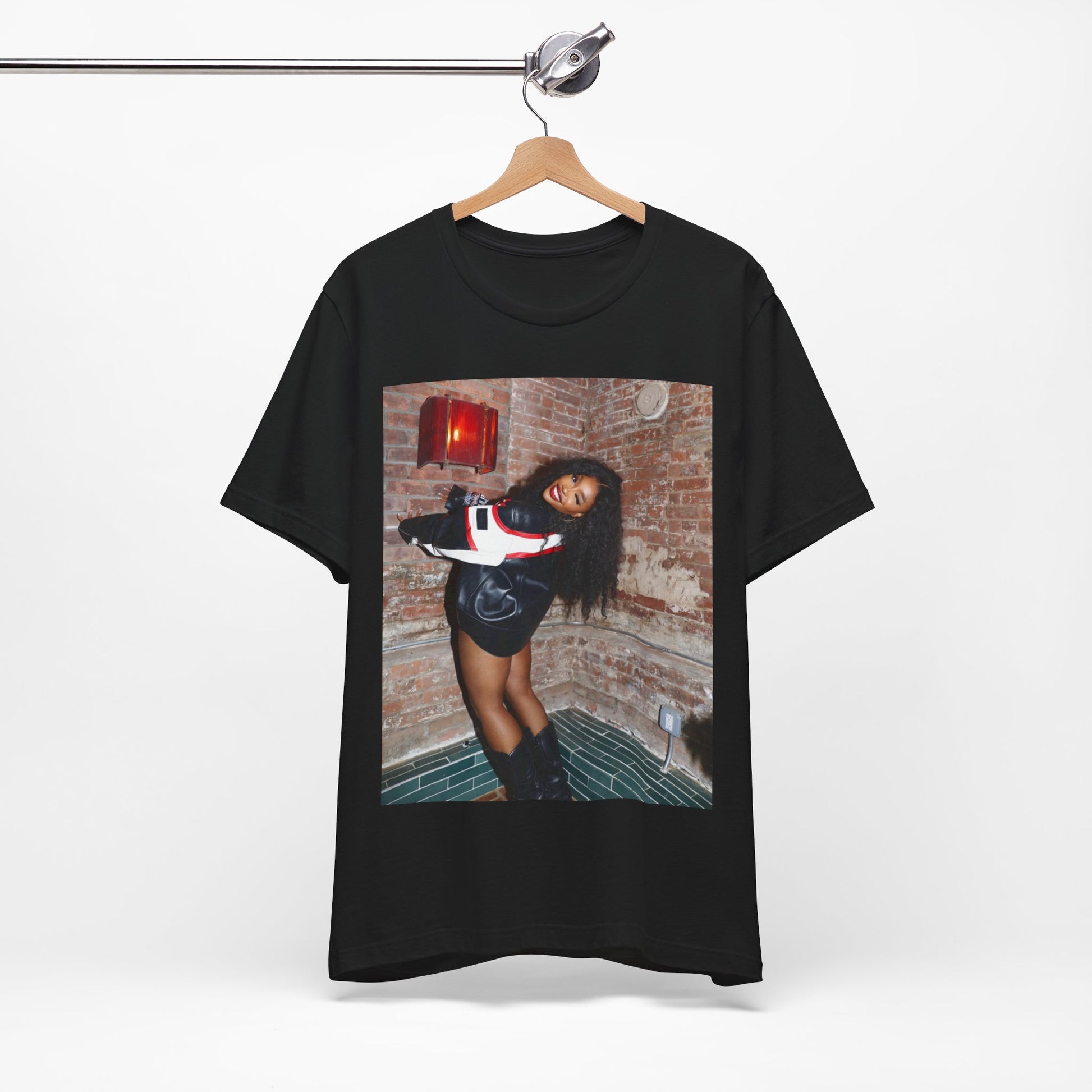 A black graphic t-shirt featuring a graphic of SZA as a TDE Queen R&B icon.