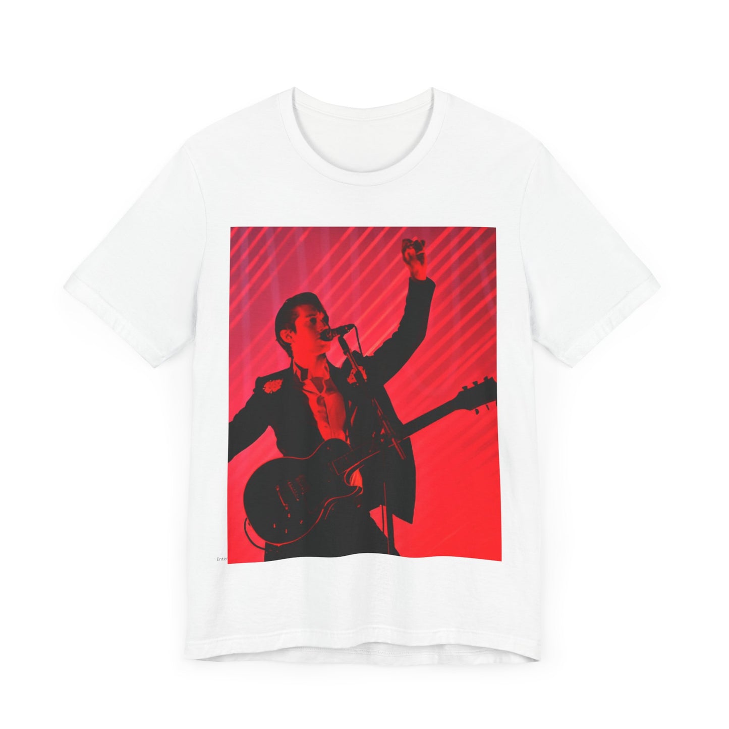 A black graphic t-shirt featuring a dynamic graphic or photo of Arctic Monkeys performing live in concert.