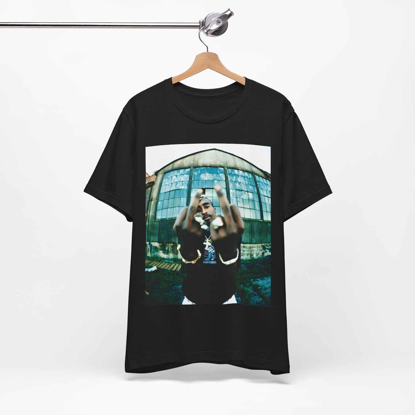 A black graphic t-shirt featuring a graphic of Tupac giving the middle finger.