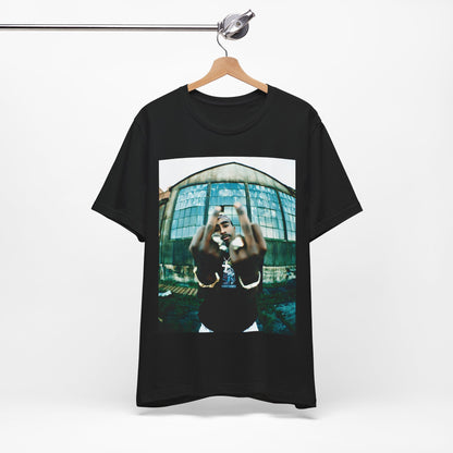 A black graphic t-shirt featuring a graphic of Tupac giving the middle finger.