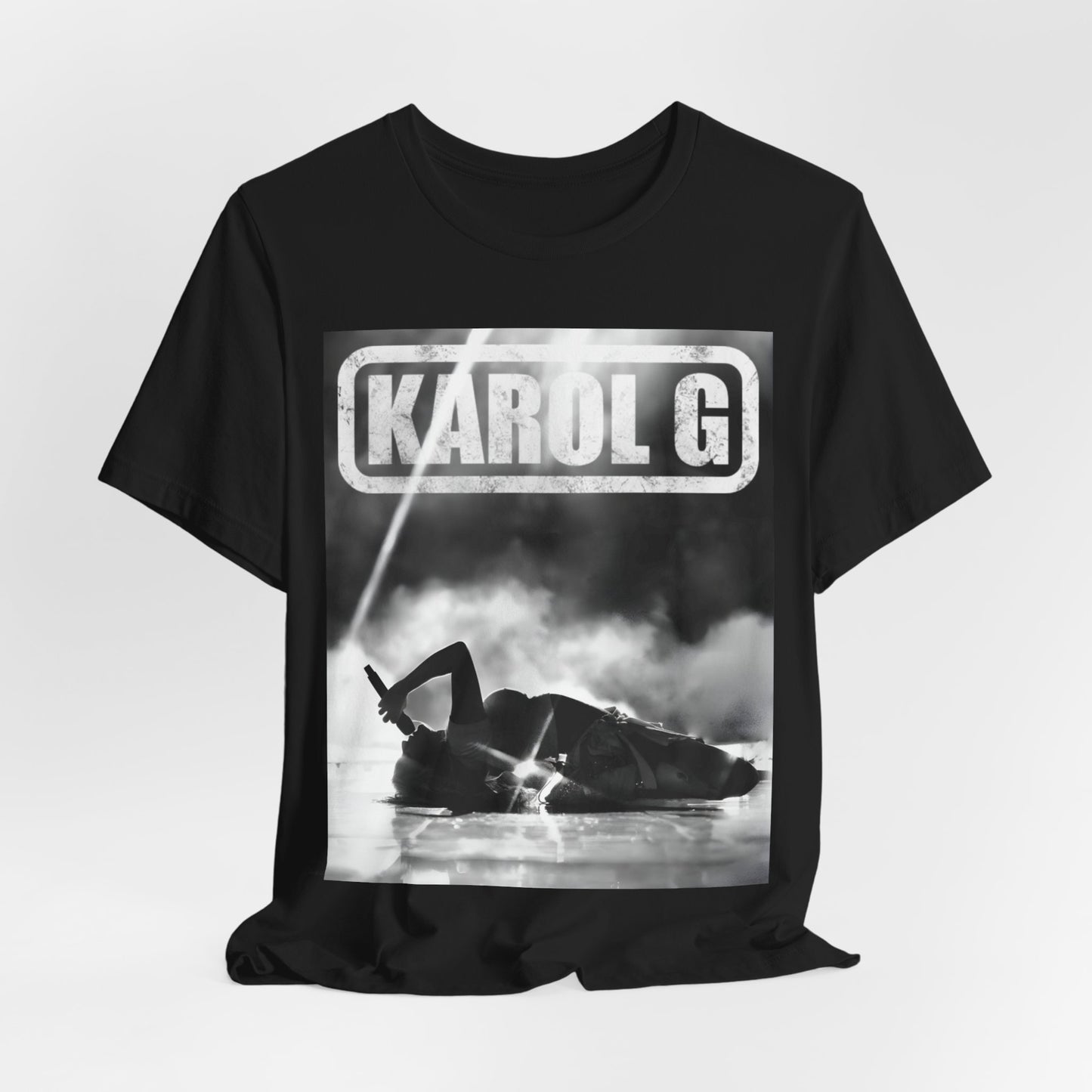 A black graphic t-shirt featuring a black and white graphic or photo of Karol G performing live on stage.