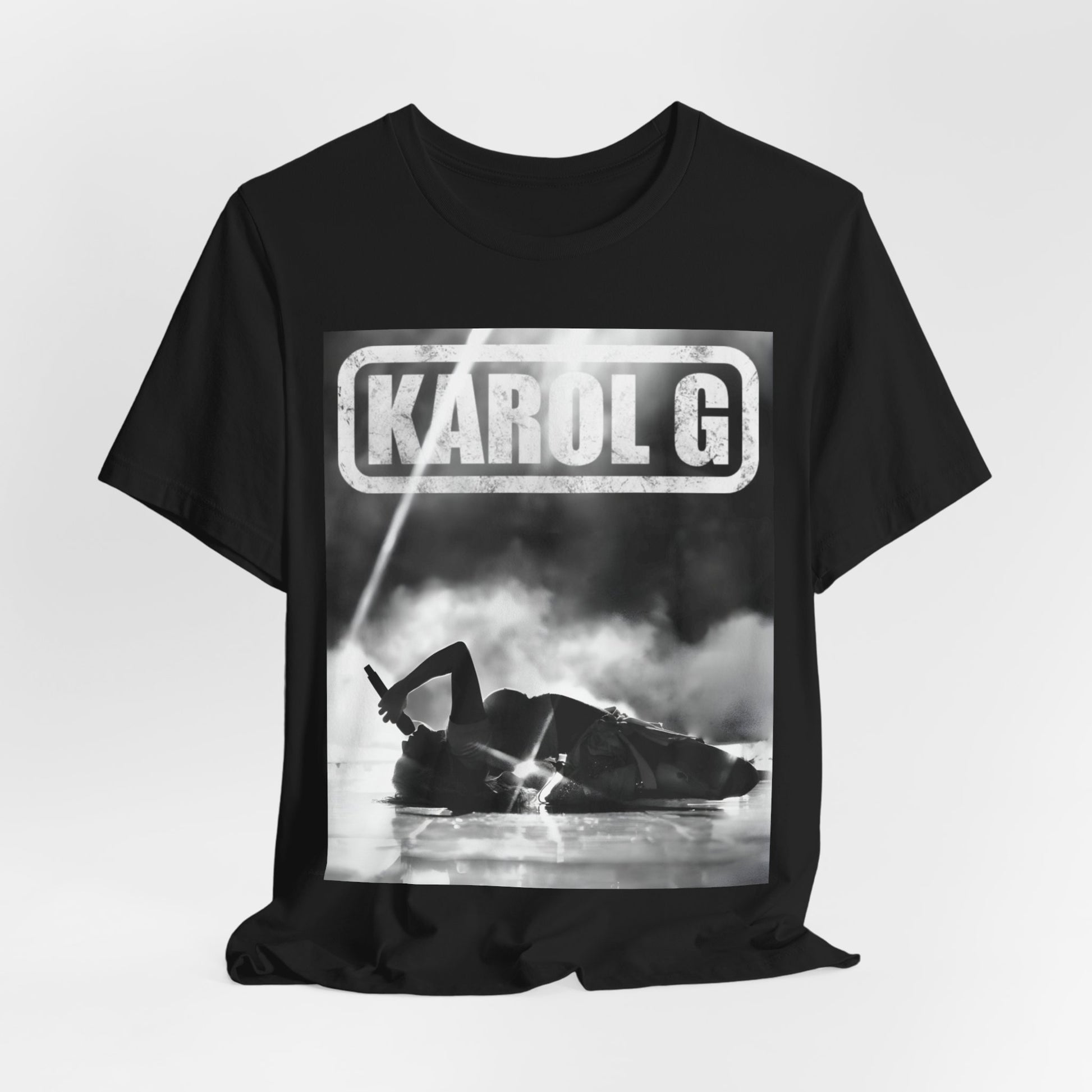 A black graphic t-shirt featuring a black and white graphic or photo of Karol G performing live on stage.