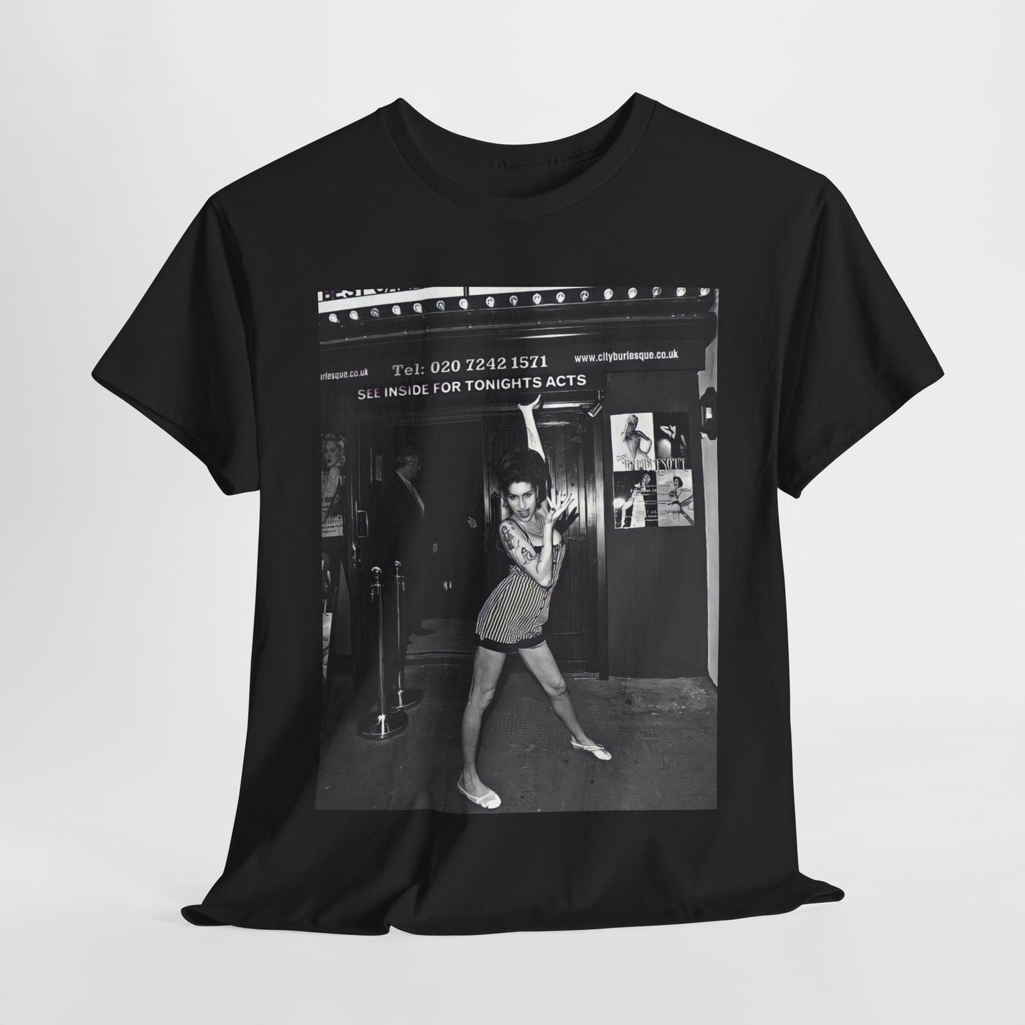 A black graphic t-shirt featuring a black and white graphic of Amy Winehouse in a burlesque club setting, stylized to evoke that ambiance.