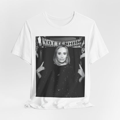 A black graphic t-shirt featuring a photo of Adele in a casual setting, surrounded by fans at a Tottenham event, showing her smiling or interacting.
