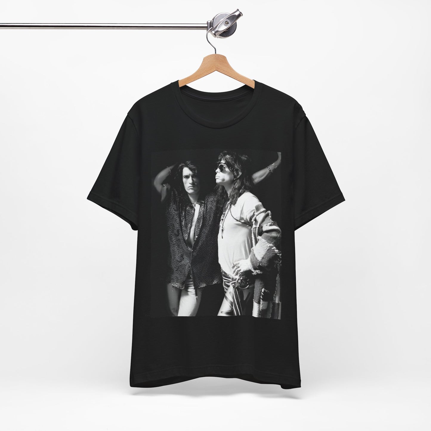 A black graphic t-shirt featuring a dynamic photo or illustration of Aerosmith's Steven Tyler and Joe Perry performing together on stage, highlighting their synergy.
