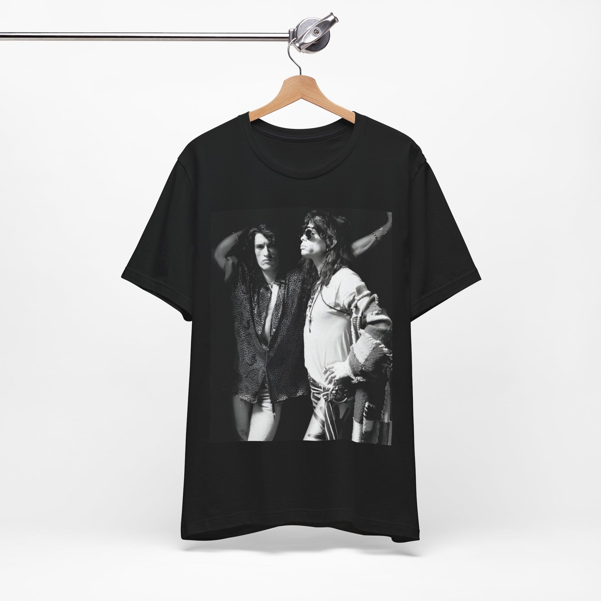 A black graphic t-shirt featuring a dynamic photo or illustration of Aerosmith's Steven Tyler and Joe Perry performing together on stage, highlighting their synergy.