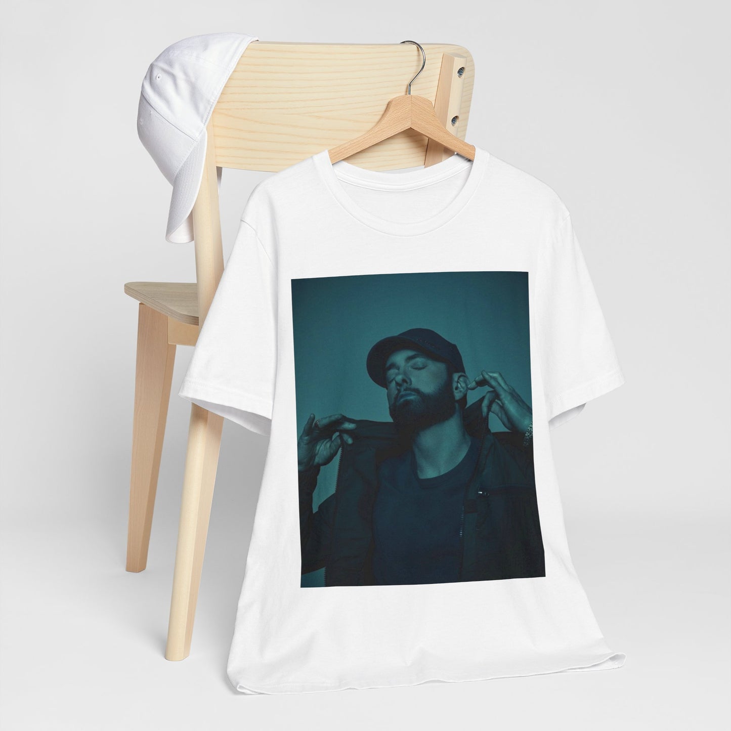 A black graphic t-shirt featuring a graphic of Eminem as a 'Rap God'.