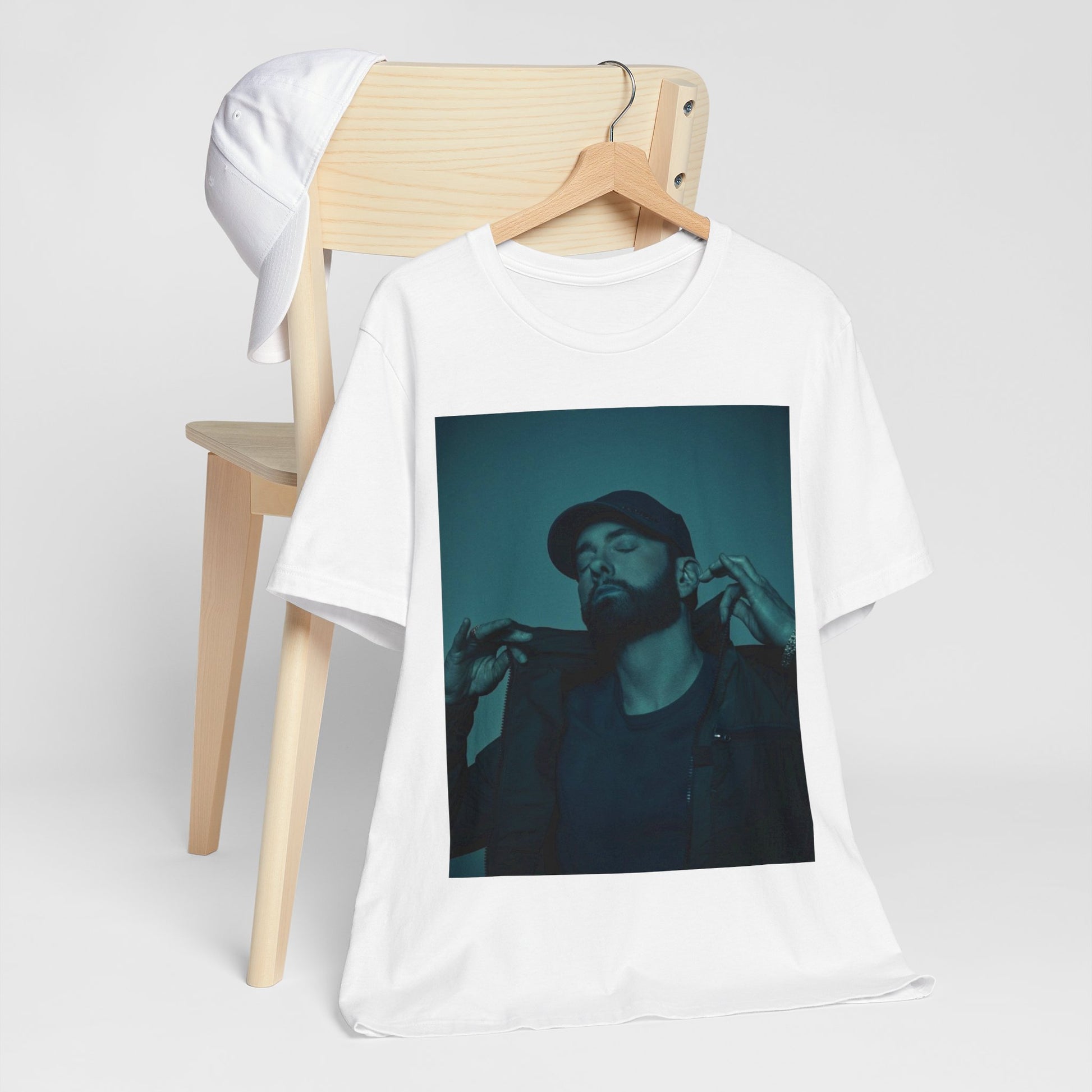 A black graphic t-shirt featuring a graphic of Eminem as a 'Rap God'.