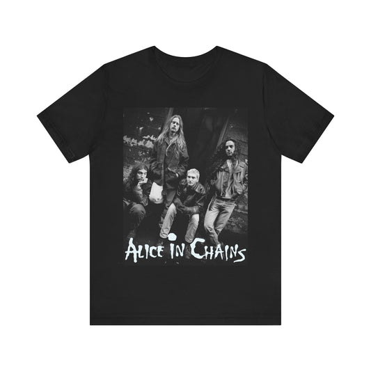 A black graphic t-shirt featuring a 90s black and white photographic portrait of the band Alice In Chains, capturing their iconic grunge look.