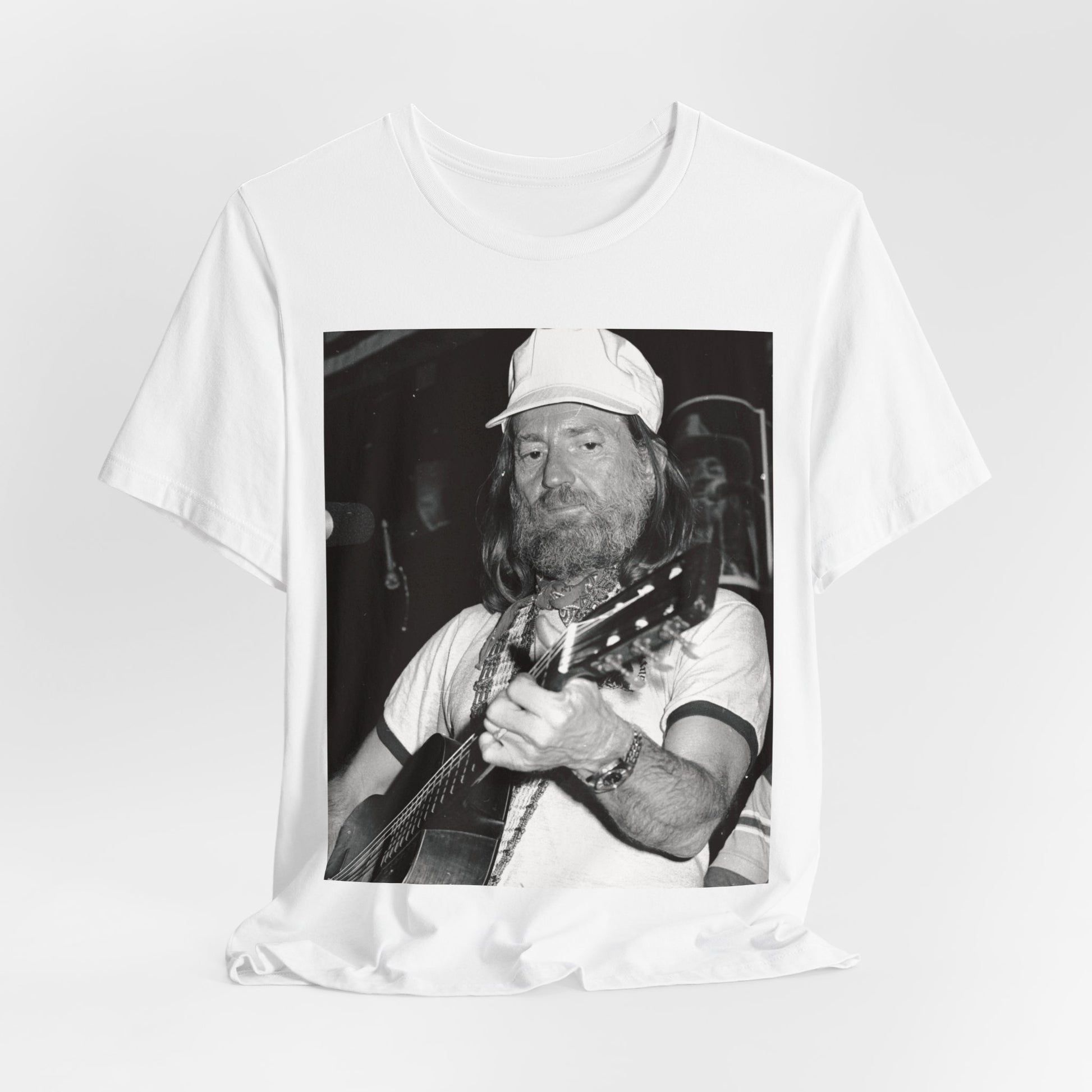 A black graphic t-shirt featuring a 70s cool free spirit graphic of Willie Nelson.