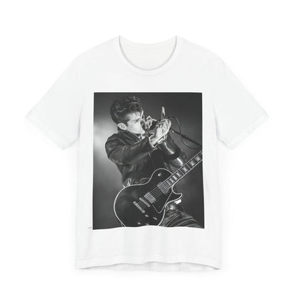 A black graphic t-shirt featuring a dynamic black and white graphic or photo of Arctic Monkeys performing live, emphasizing energy.