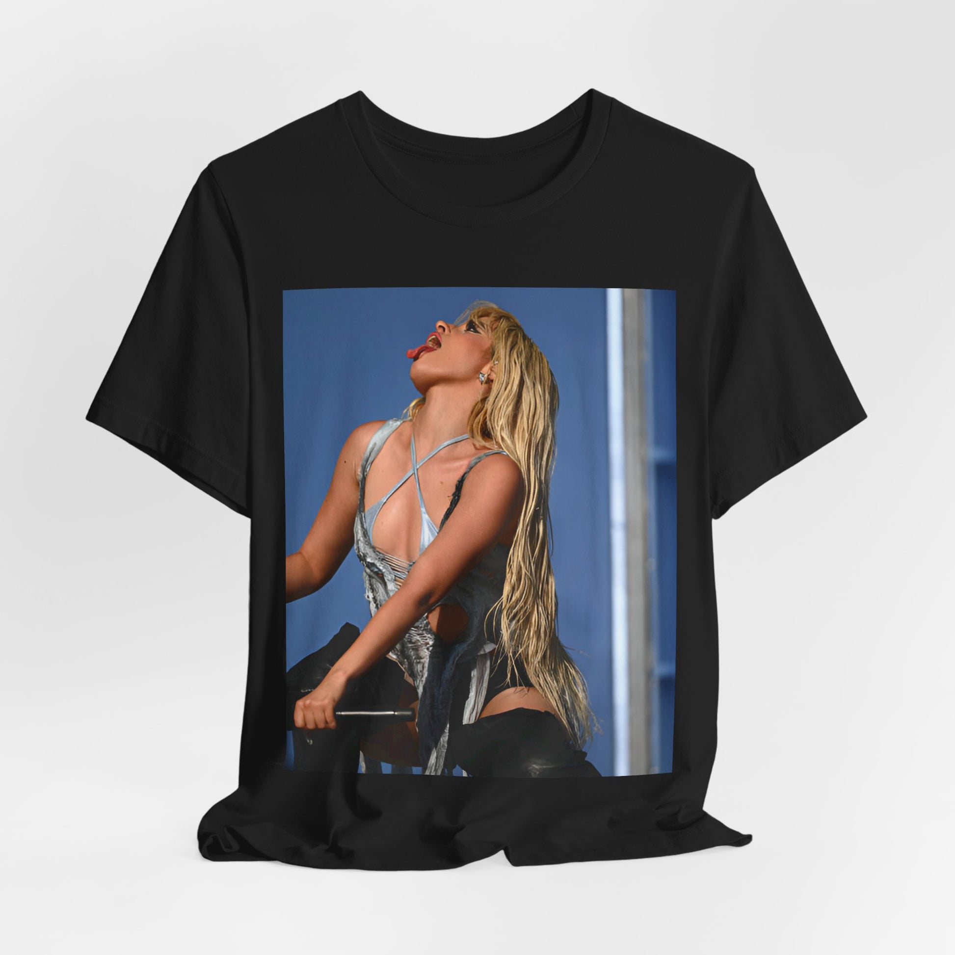 A black graphic t-shirt featuring a dynamic graphic or photo of Camila Cabello performing live on stage.