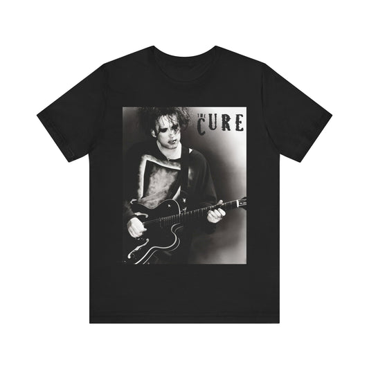 A black graphic t-shirt featuring a vintage goth rock graphic of The Cure.