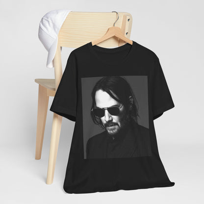 A black graphic t-shirt featuring a graphic of Keanu Reeves with a rebel spirit aesthetic.