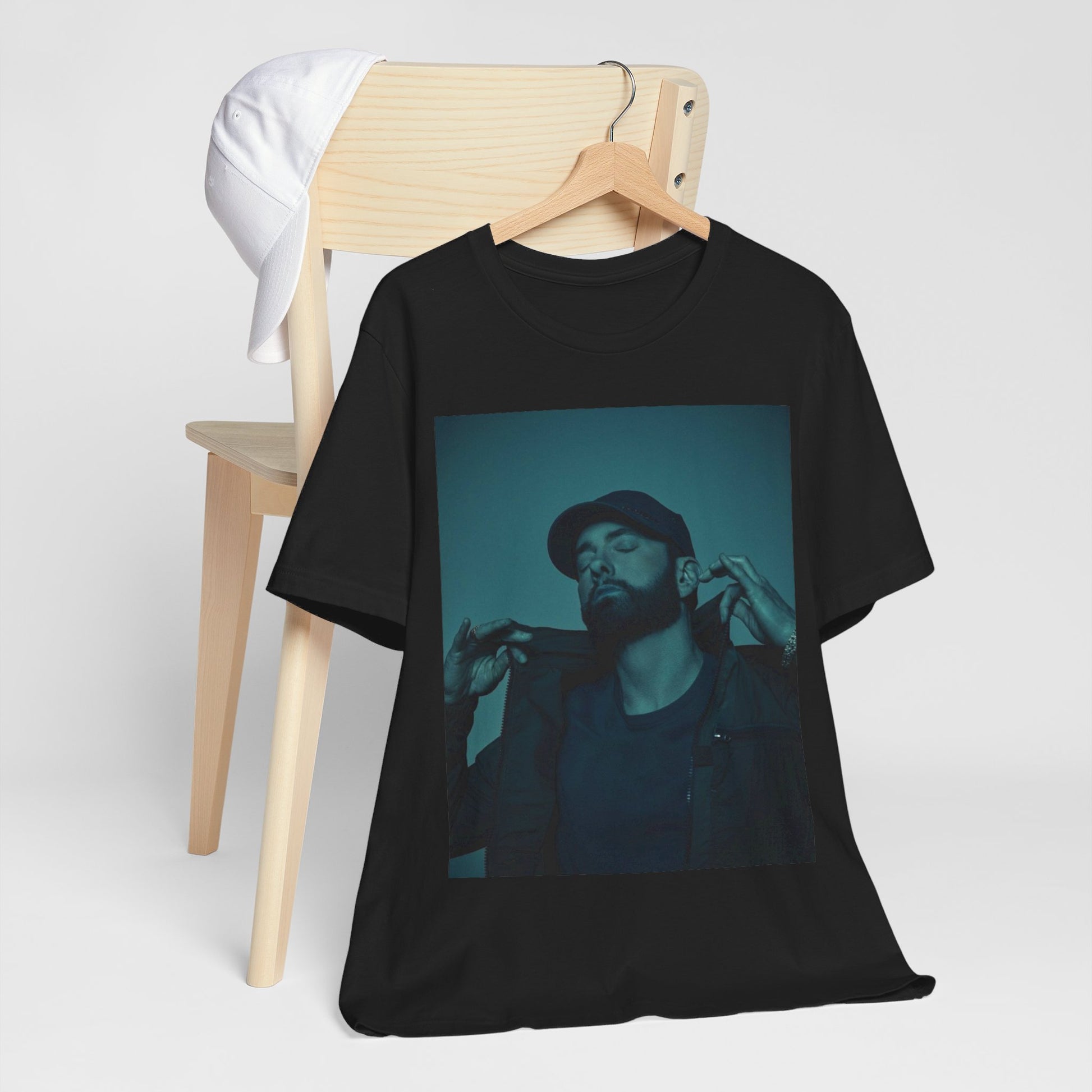 A black graphic t-shirt featuring a graphic of Eminem as a 'Rap God'.