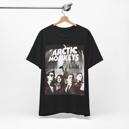 A black graphic t-shirt featuring a retro-style logo for the band Arctic Monkeys.