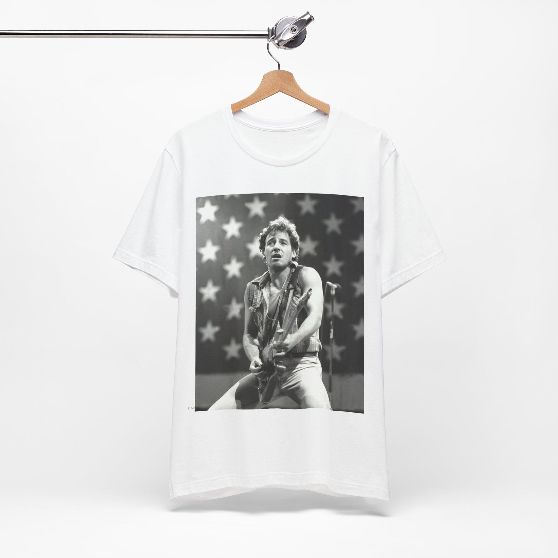 A black graphic t-shirt featuring a black and white graphic of Bruce Springsteen with an American flag background or elements.
