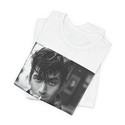 A black graphic t-shirt featuring a graphic of Alex Turner from Arctic Monkeys, in a rock star pose or setting.