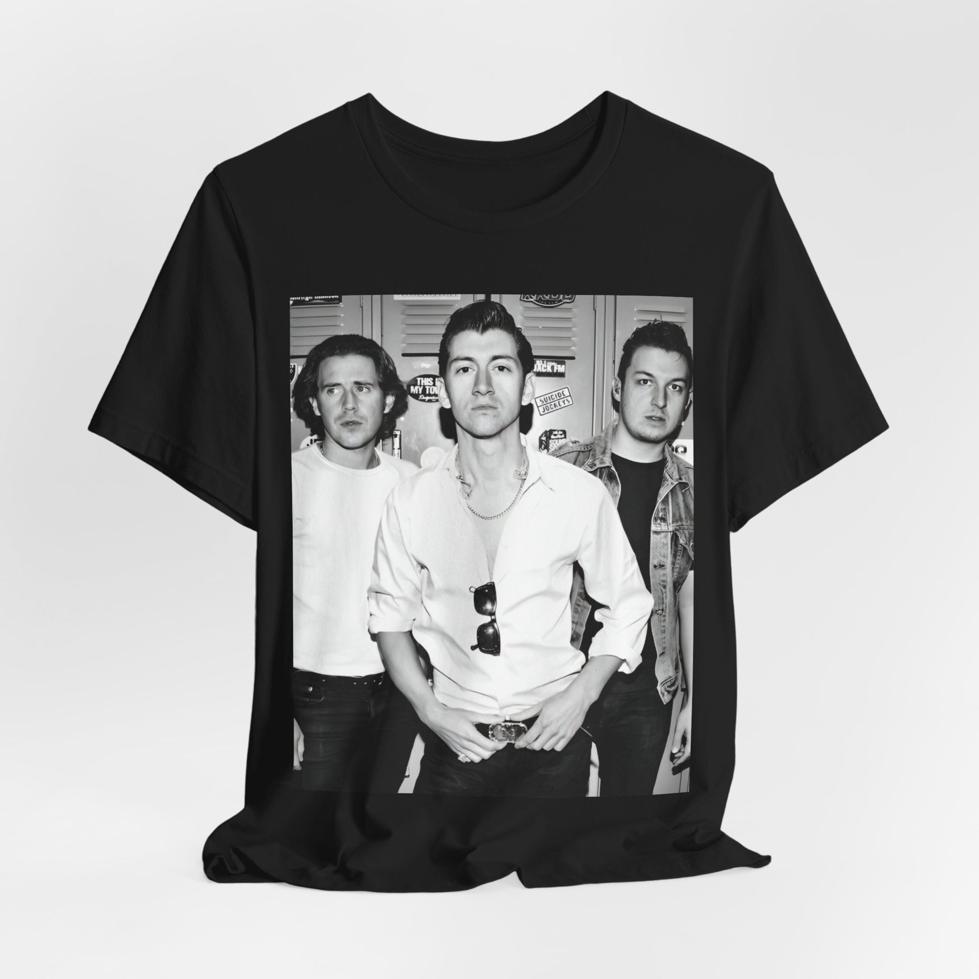 A black graphic t-shirt featuring a vintage-style design related to Arctic Monkeys' 'AM' album era, possibly with the album art or band imagery.