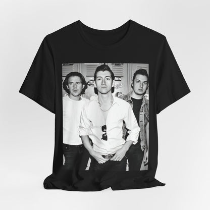 A black graphic t-shirt featuring a vintage-style design related to Arctic Monkeys' 'AM' album era, possibly with the album art or band imagery.