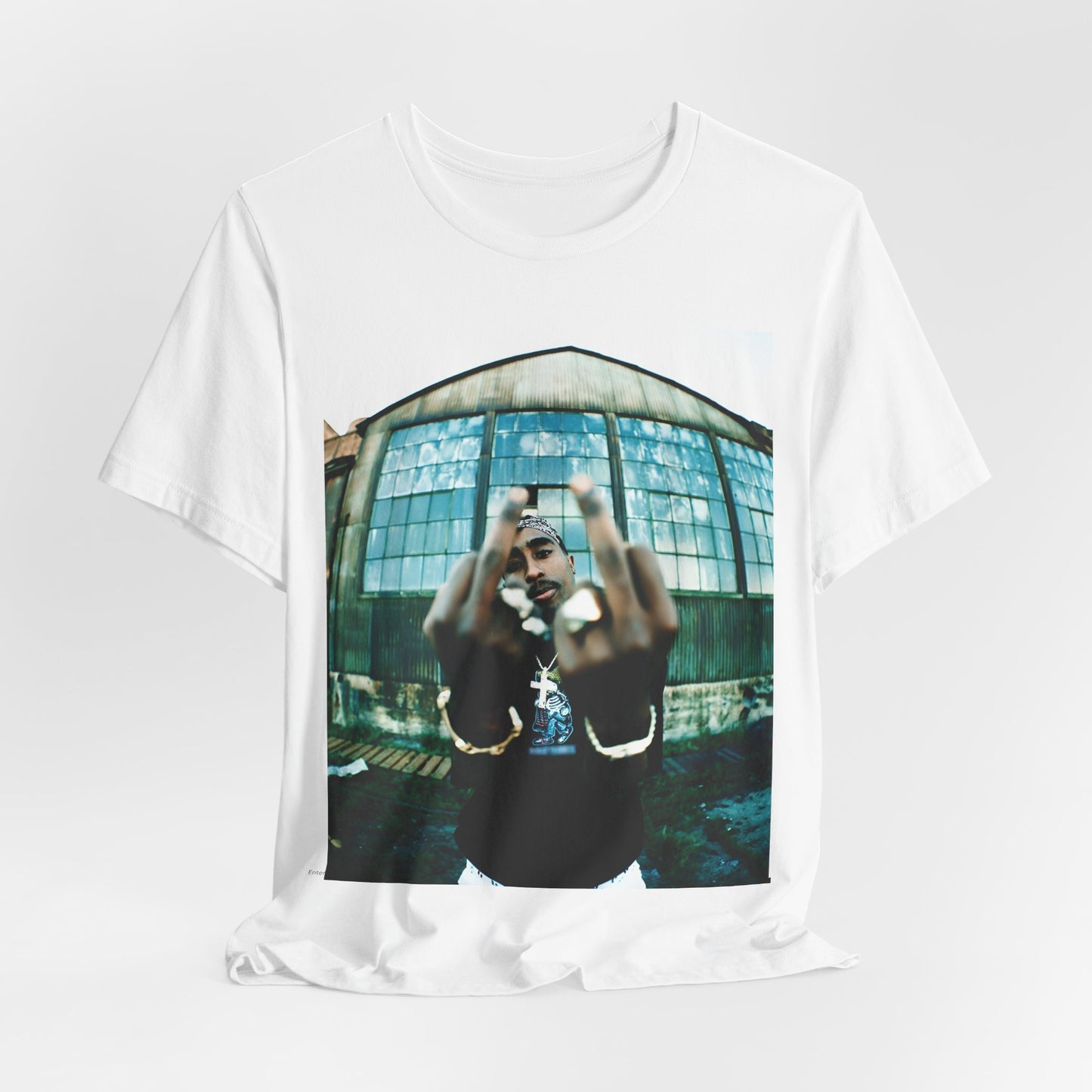 A black graphic t-shirt featuring a graphic of Tupac giving the middle finger.